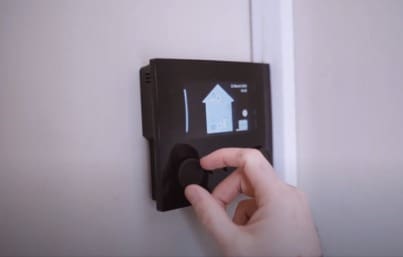 Solar And Heat Pump Installation Monaghan Case Study Results Image showing the customer adjusting their their heat pump settings.