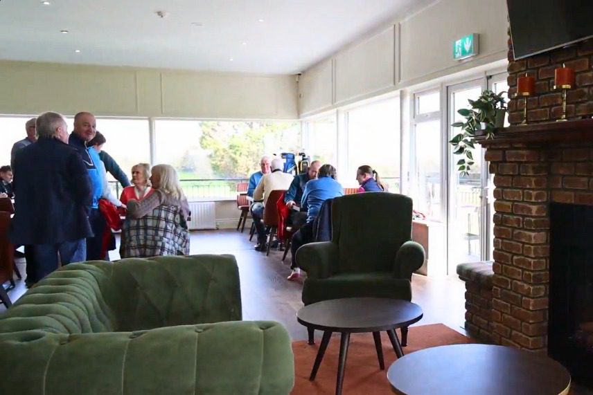 Golf Club Solar Panel Installation Inside Clubhouse Image showing happy customers sitting and standing in the function room.