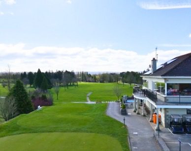 Golf Club Solar Panel Installation Tee Off Image showing solar panels on the clubhouse to the right and the golf course to the left.