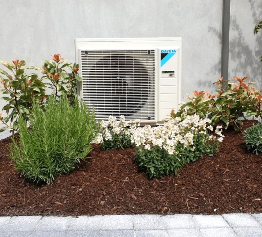 An air to water heat pump in a garden in Ireland installed by Ohk energy