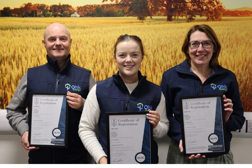 3 Ohk energy team members holding 3 ISO certifications