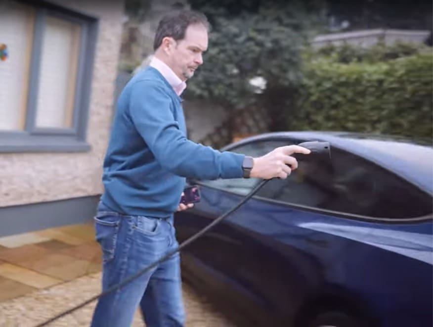 Solar Installation Dublin Case Study Image showing Cyril about to plug his EV charger into his electric vehicle.