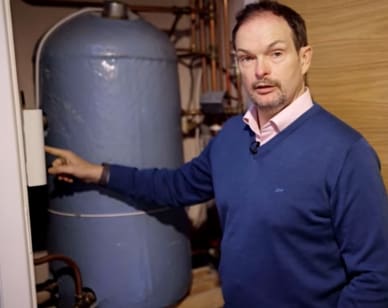 Solar Installation Dublin Video Preview Image of Cyril pointing to his Eddi hot water diverter.