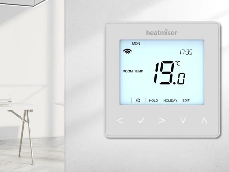 Air To Water Heat Pump Thermostat Video Preview Image showing a Heatmiser neoStat v2 on a wall in a room.