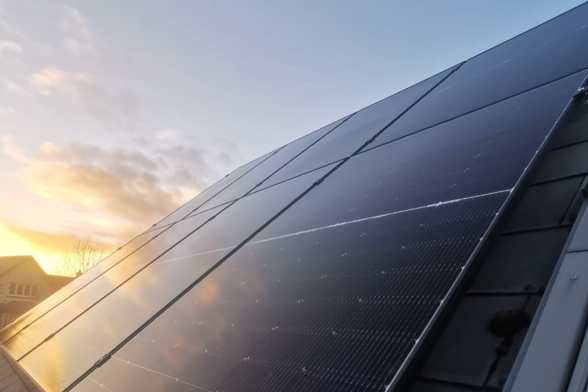 Grants For Solar Panels Featured Image showing solar panels installed on a rook by Ohk energy.