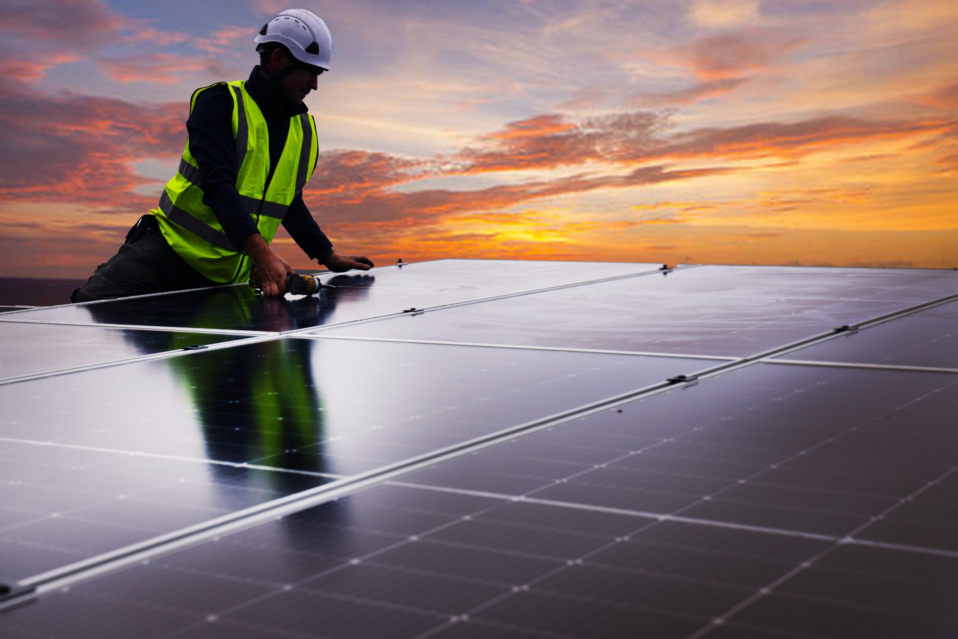 Solar Panels Cost Image showing an Ohk energy electrician installing solar panels.