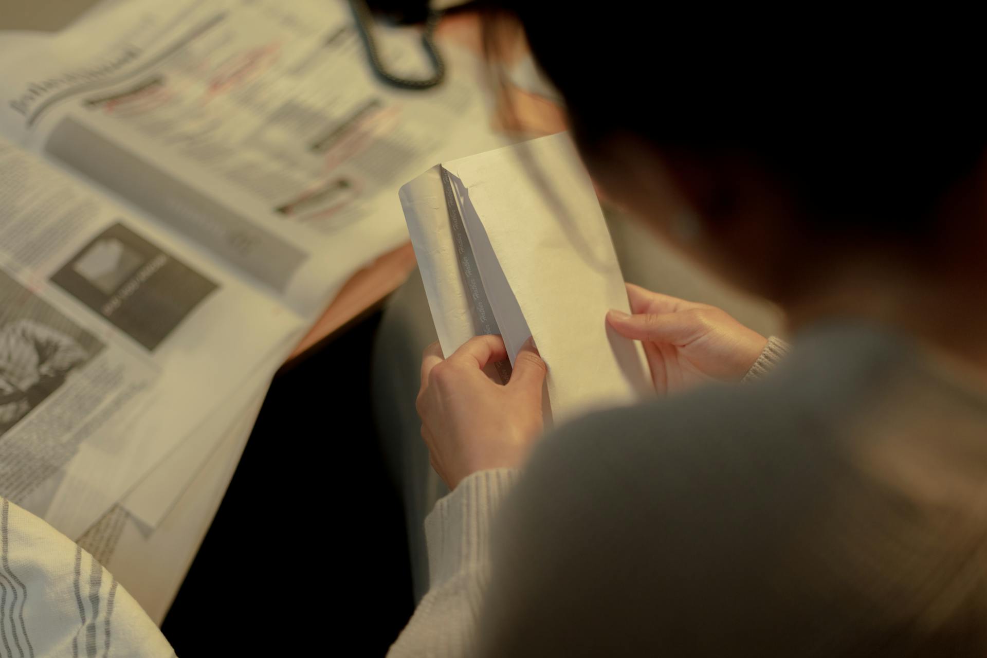 Rising Network Charges Image showing a person opening their electricity bill.