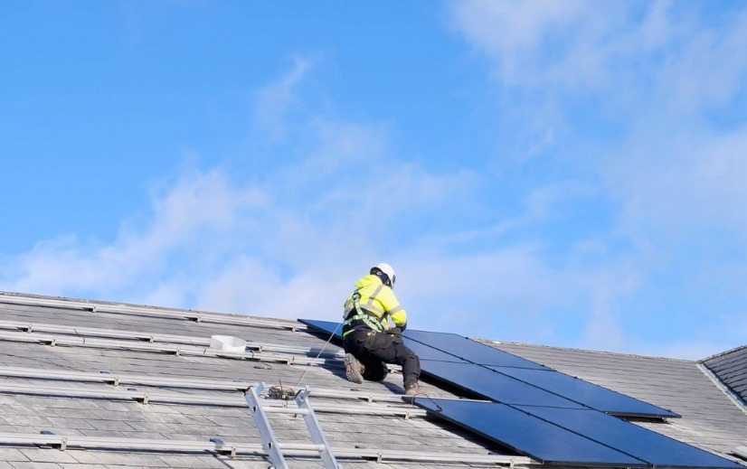 Rooftop Solar Installation In Progress Image showing an Ohk energy roofer installing solar panels on a rooftop.