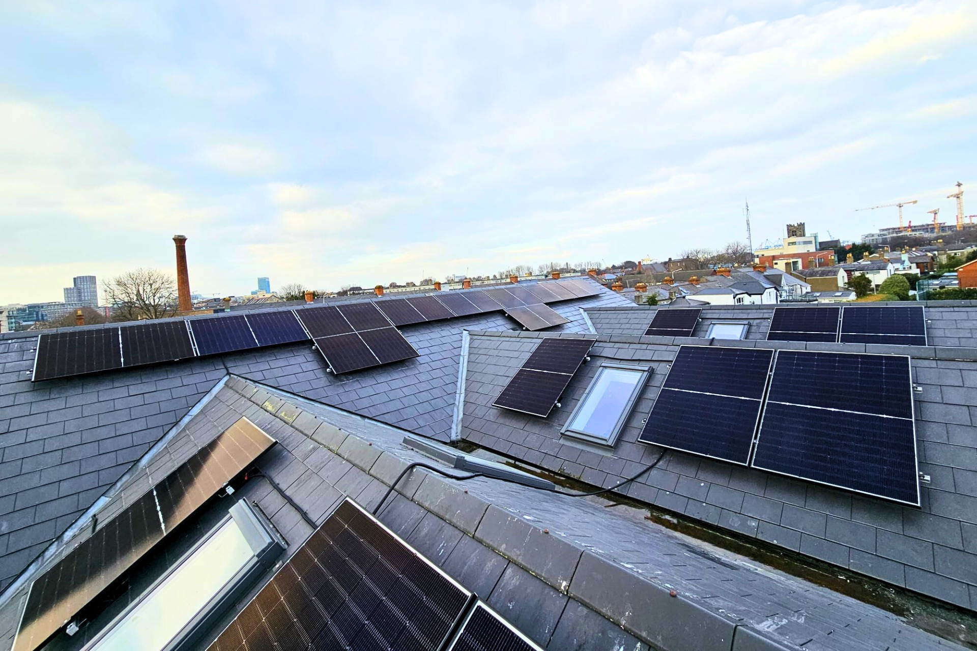 Rooftop Solar Installation Image showing solar panels installed on multiple pitched roofs.