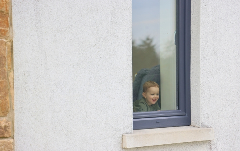 One Stop Shop Service Window Upgrade image showing a child looking out a newly installed window.
